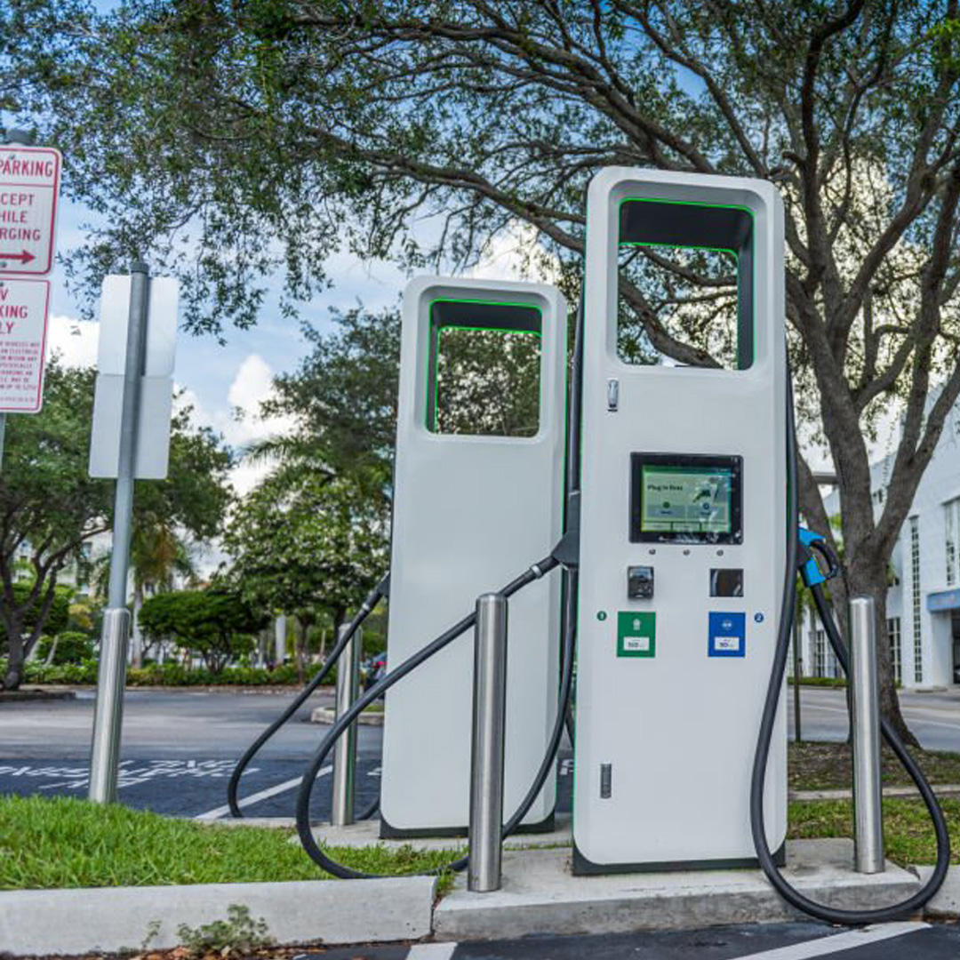 A compact Level 2 AC electric vehicle charger with Type 2 cable mounted on a sleek garage wall with LED status indicators.