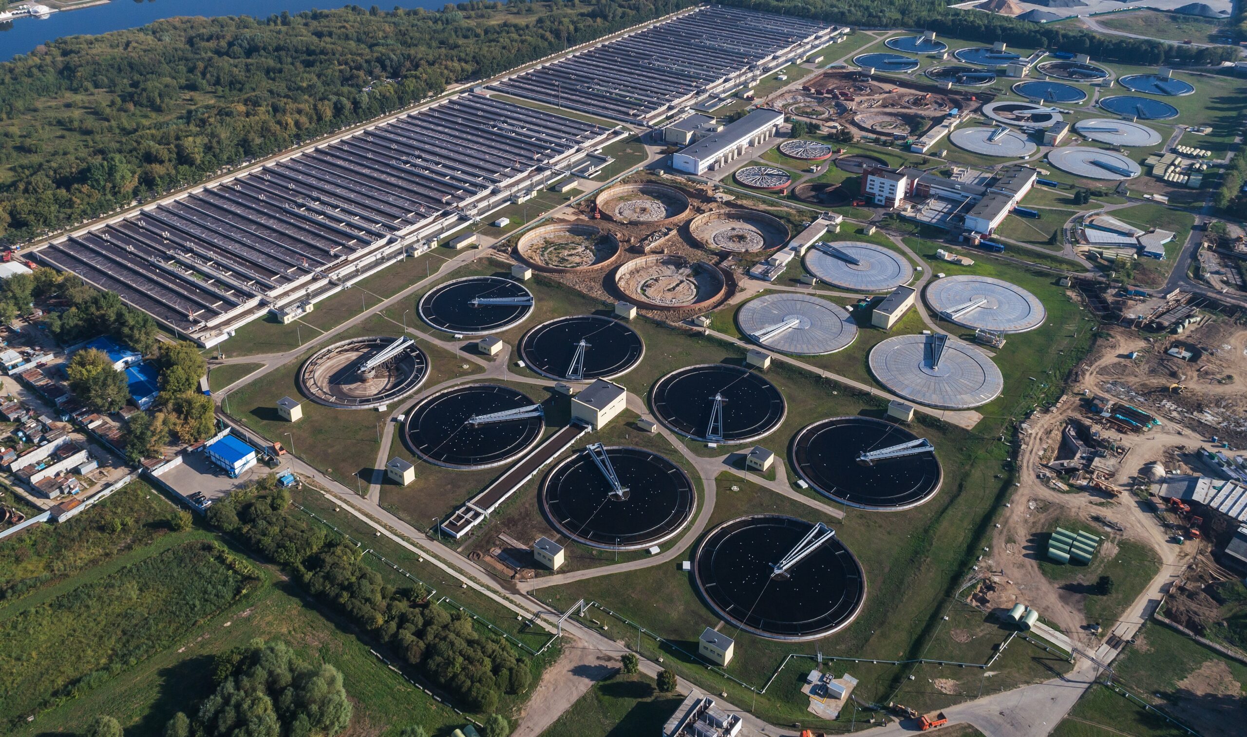 A large-scale desalination plant featuring energy recovery devices, high-pressure pump skids, and membrane filtration units for seawater processing.
