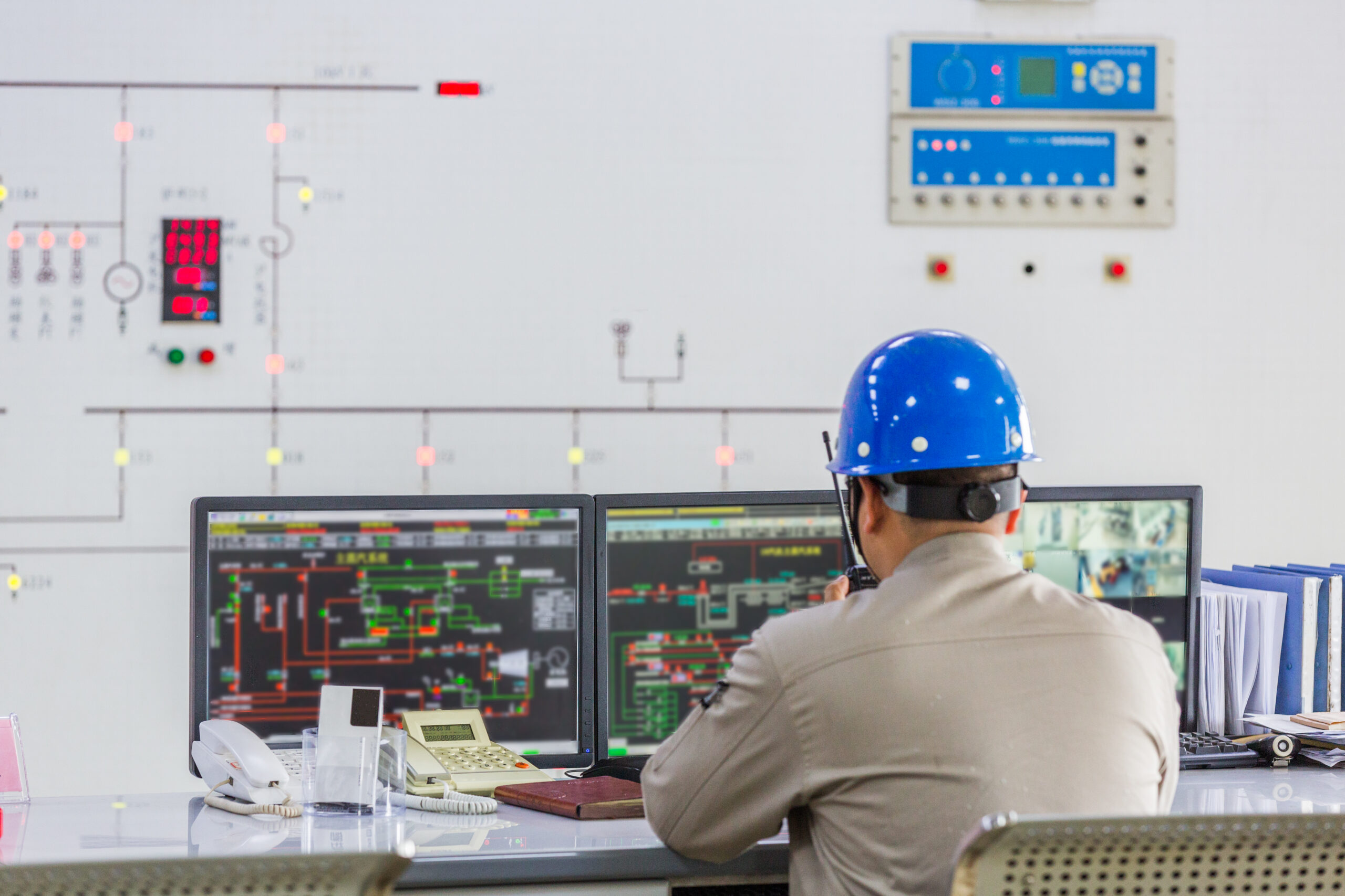 High-resolution monitoring screen displaying real-time system performance data, process flow diagrams, and equipment status alerts for an industrial plant.