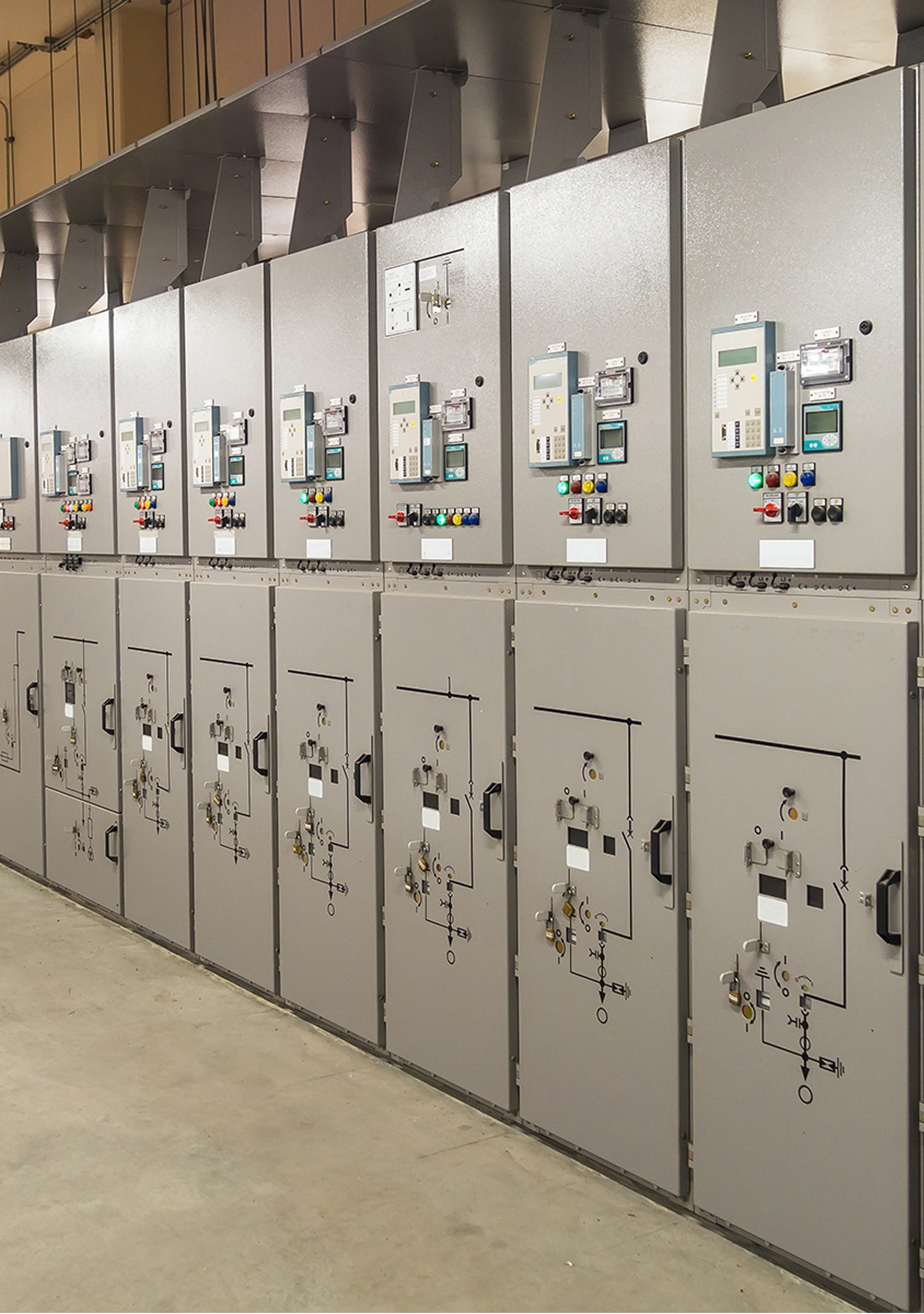 A professional medium voltage distribution system showing multiple switchgear cubicles with protective relays and circuit breakers for industrial power control.