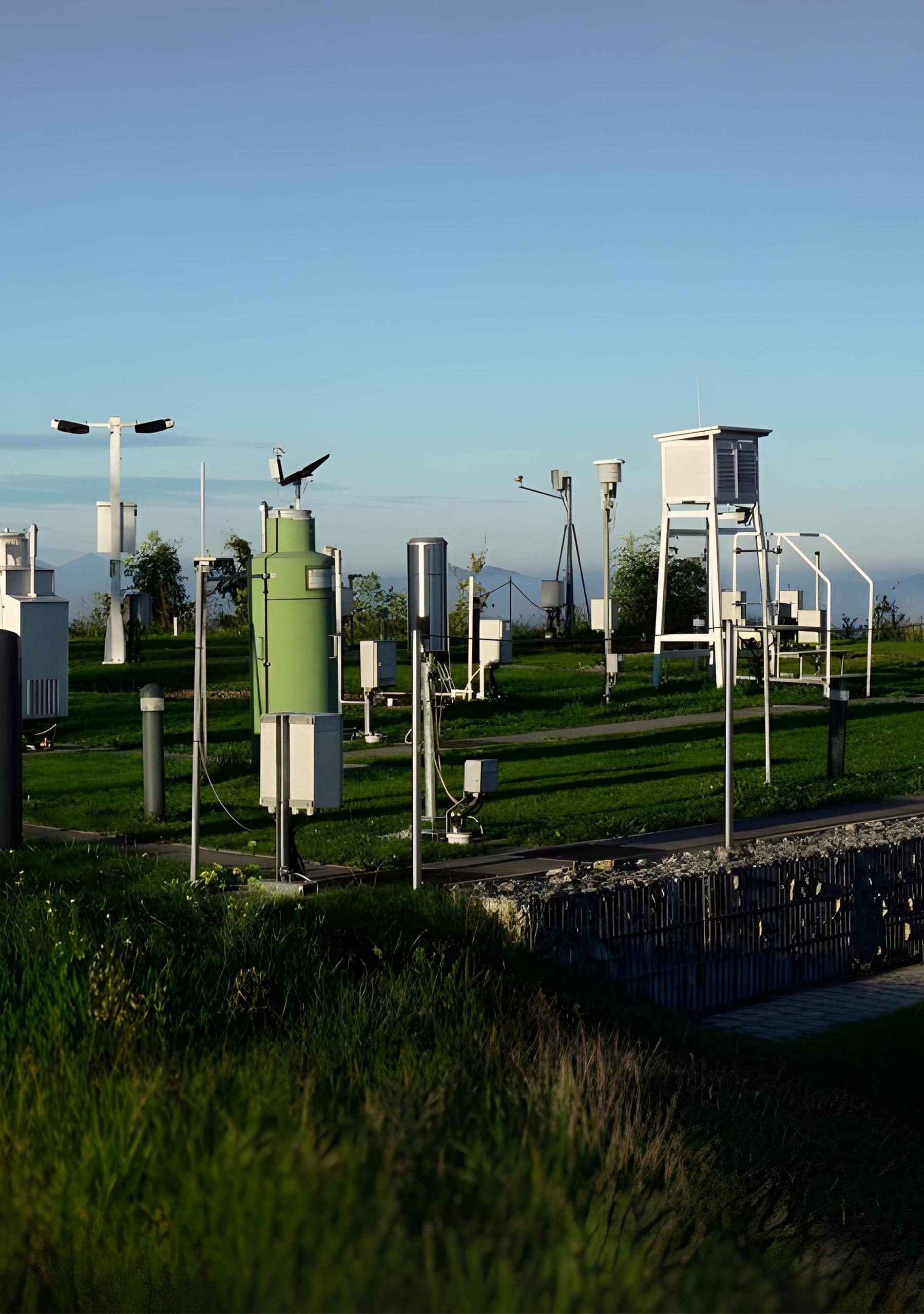 Automated hydrometeorological station installed near a river bank measuring water level and atmospheric pressure.