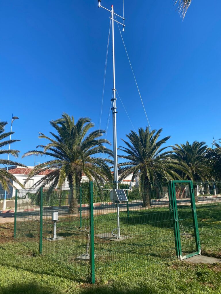 A compact meteorological sensor equipped with a small solar panel for autonomous power supply in a remote field.